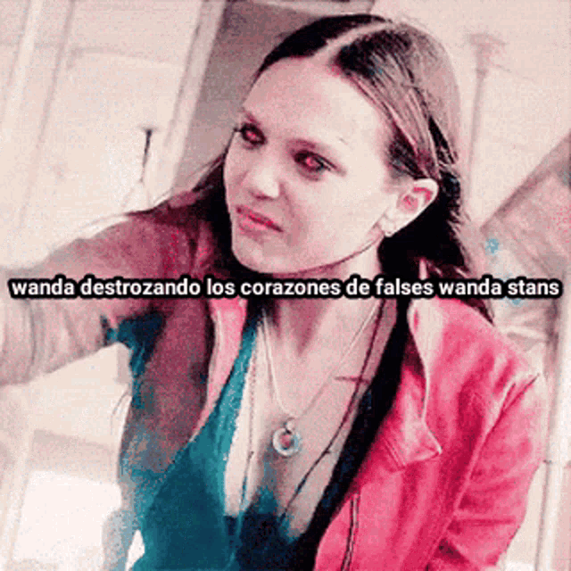 a woman in a red jacket with the words wanda destrozando los corazones de falses wanda stans written above her