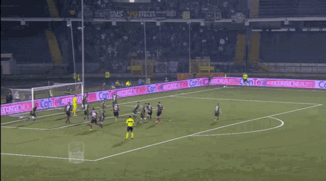 a soccer game is being played on a field with a banner that says comte