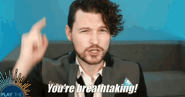 a man in a suit and tie is saying " you 're breathtaking "