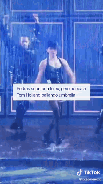 a man and a woman are dancing in the rain with a caption that says tom holland bailando umbrella