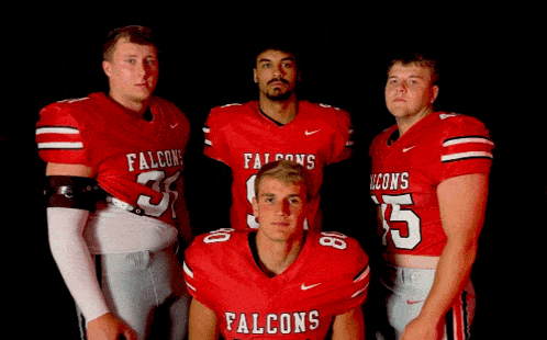 a group of falcons football players pose for a photo