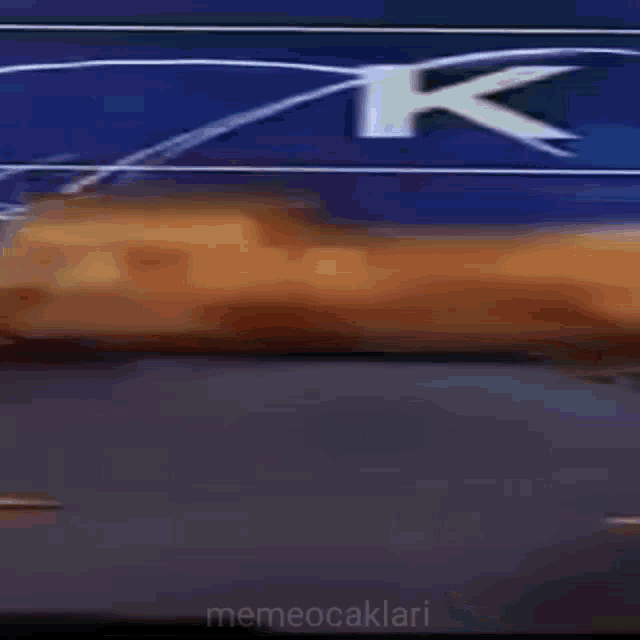 a car is driving down a road in front of a sign that says ' s ' on it
