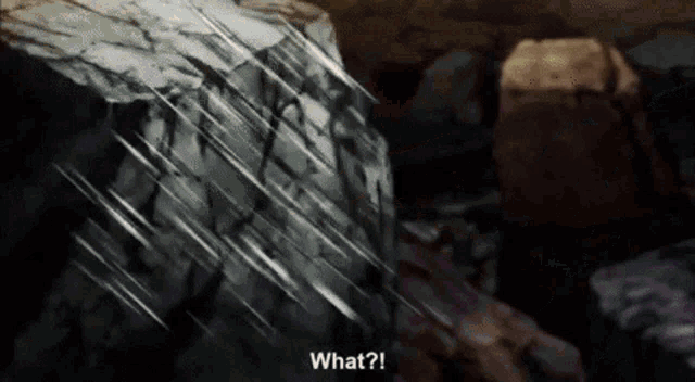 a person is standing in front of a large rock and says what .