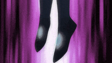 a close up of a person 's feet on a stage with a purple curtain in the background .