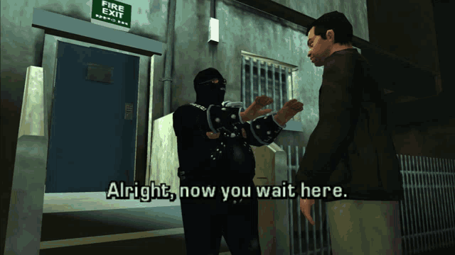 a man in handcuffs talking to another man in front of a fire exit sign