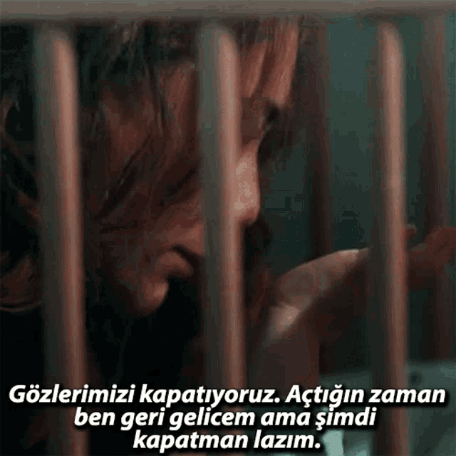 a woman in a cage with a caption that says " gözlerimizi kapatiyoruz "
