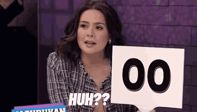 a woman is holding a sign with the number 00 on it and says huh ?