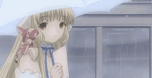 a girl is walking down a street with an umbrella .