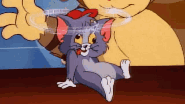 a cartoon cat with a red bow on its head