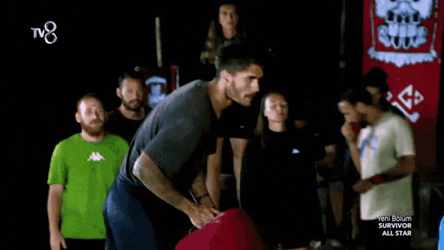 a group of people watching a survivor all star show