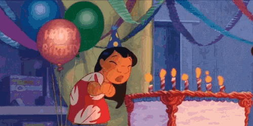 a cartoon character is blowing out the candles on a birthday cake .