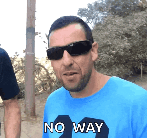 a man wearing sunglasses and a blue shirt with the word no way on it