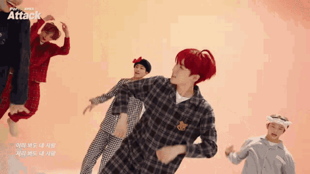 a group of young men are dancing in front of an orange background that says attack on it