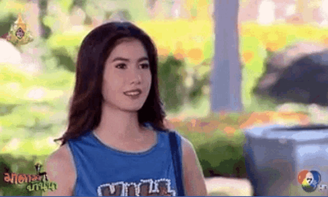 a woman is wearing a blue tank top that says ' a ' on the front