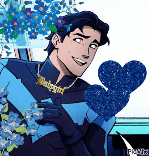 a man wearing a babygirl necklace holds a heart in his hand