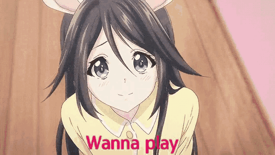 a girl with bunny ears and the words `` wanna play '' on the bottom of her face .