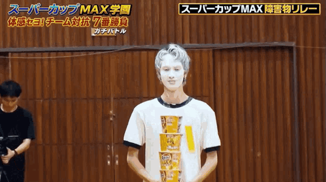 a person with white paint on their face is holding a stack of cups