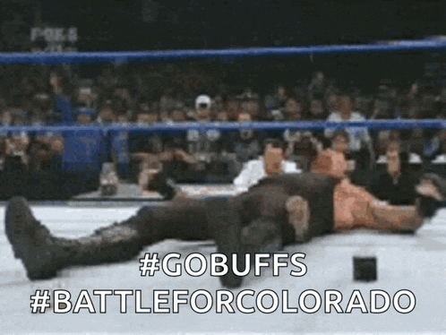 a wrestler is laying on the ground with the words #gobuffs #battleforcolorado