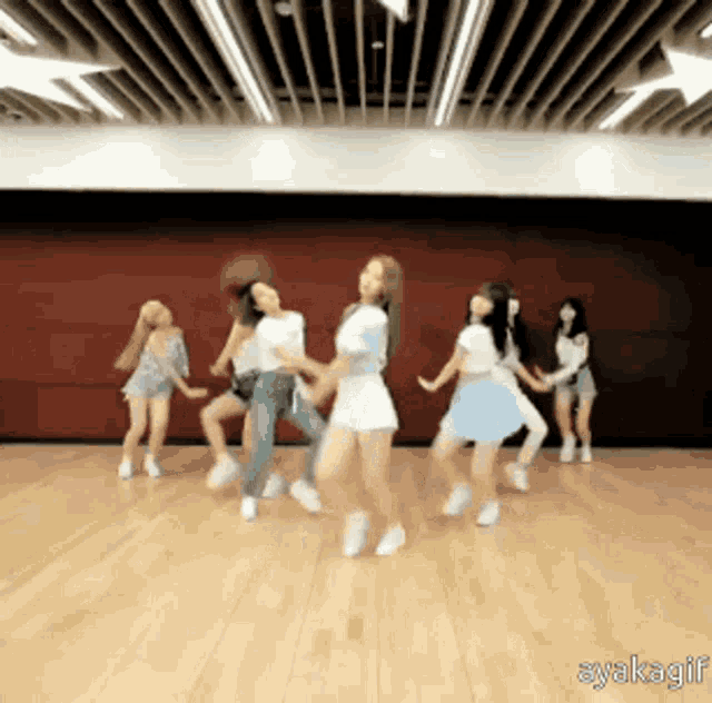 a group of young women are dancing in a room with the words syakagif written on the bottom