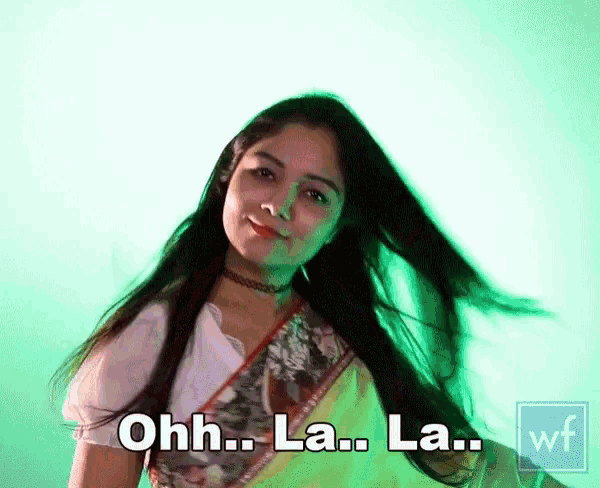 a woman with long hair is dancing and says ohh la la la