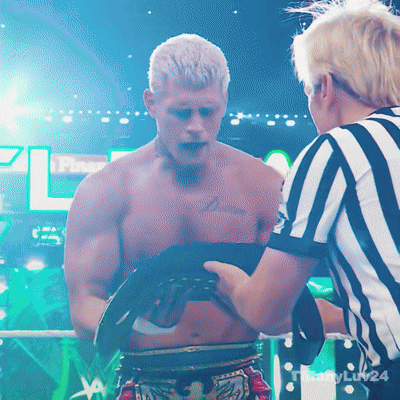 a referee talks to a shirtless boxer in a boxing ring with the letters pl on the bottom right