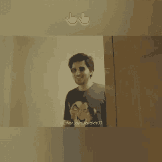 a man wearing sunglasses and a shirt with a picture of a lion king on it