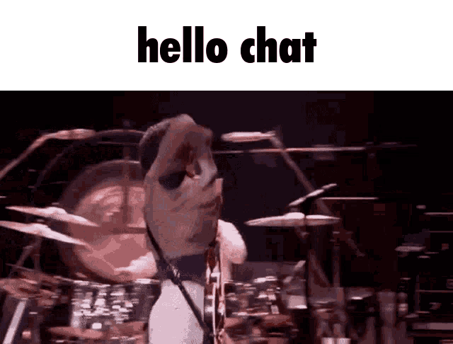 a man playing drums on stage with the words hello chat below him