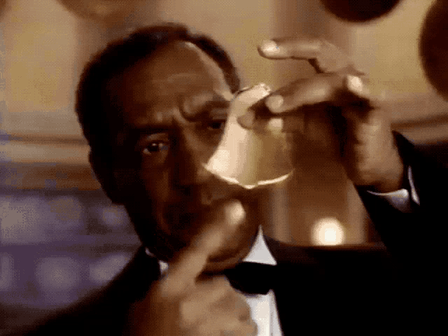 a man in a tuxedo is pointing at something