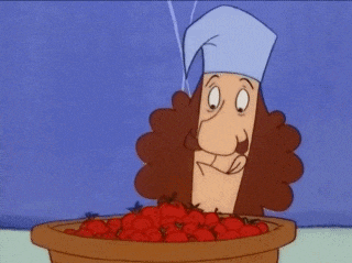 a cartoon character with a chef 's hat is eating tomatoes from a bowl .