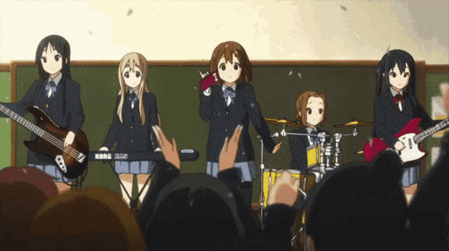 a group of anime girls are playing instruments in front of a crowd including a korg keyboard