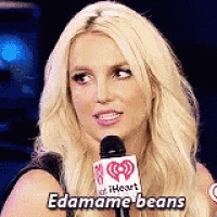 britney spears is talking into a microphone and saying `` edamame beans '' .