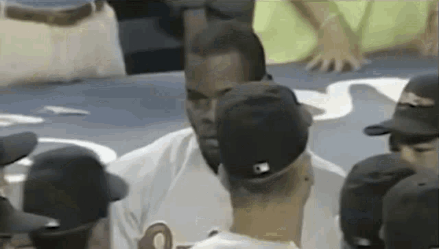 a group of baseball players are sitting in a stadium .