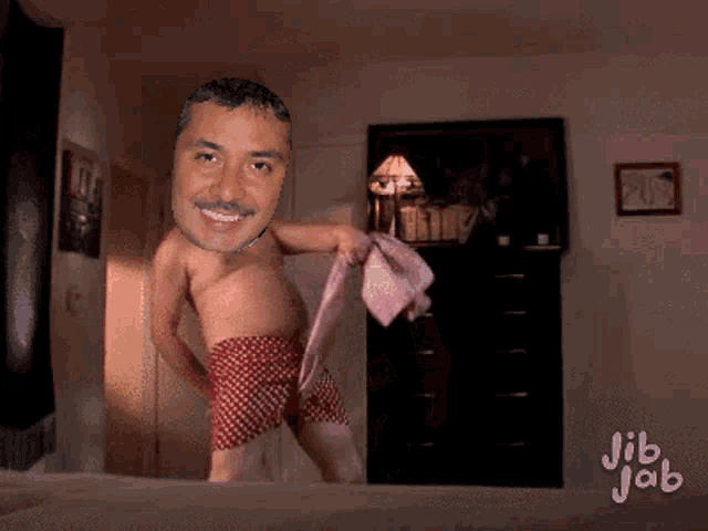 a man without a shirt is dancing on a bed with jib jab written on the bottom of the image