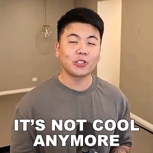 a man is wearing a gray shirt and says it 's not cool anymore