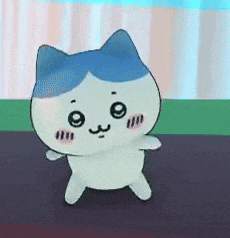 a cartoon cat with a blue head is standing on a table .