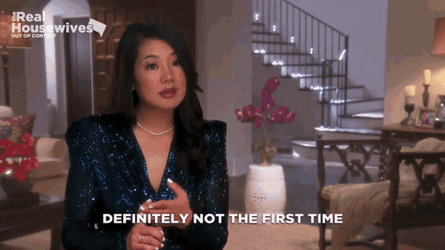 a woman says " definitely not the first time " while standing in a living room