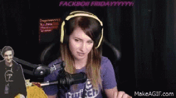 a woman wearing headphones and a purple shirt that says twitch is sitting in front of a microphone