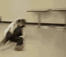 a person is laying on the floor in a room with a table in the background .