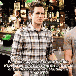 a man in a plaid shirt is standing in front of a bar and talking to another man .