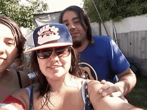 a woman wearing sunglasses and a hat that says ed hardy