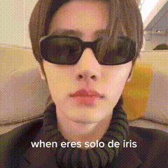 a close up of a person wearing sunglasses with the words when eres solo de iris below them .