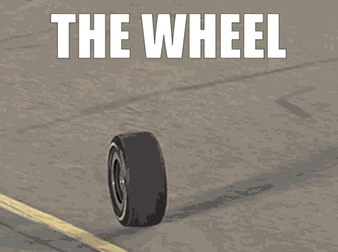 a tire on a road with the words " the wheel " below it