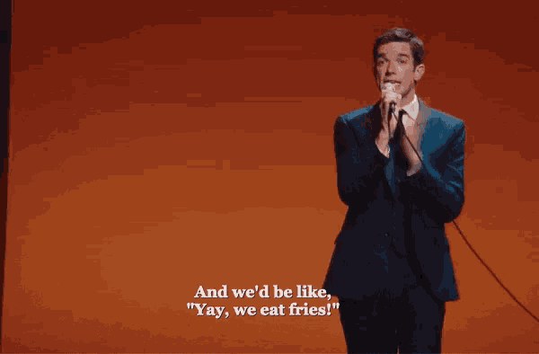 a man singing into a microphone with the words and we 'd be like " yay we eat fries "