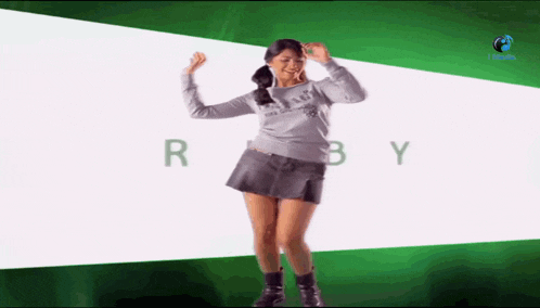 a woman is dancing in front of a green background that says ruby