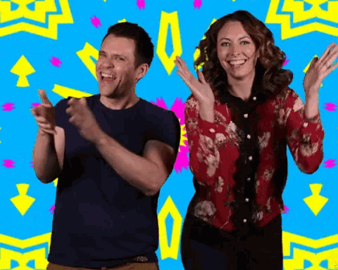 a man and a woman are clapping their hands in front of a blue background