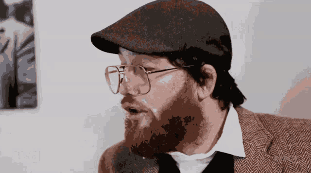 a man with a beard wearing glasses and a hat with usa written in the corner