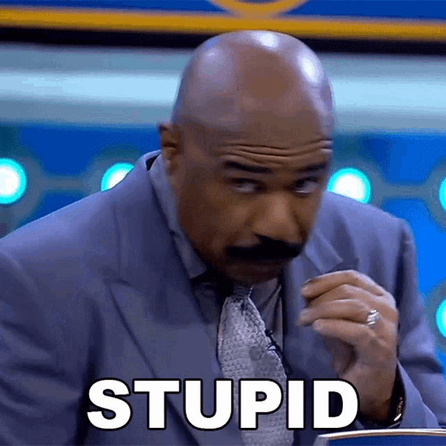 a man in a suit and tie with the word stupid written on his face