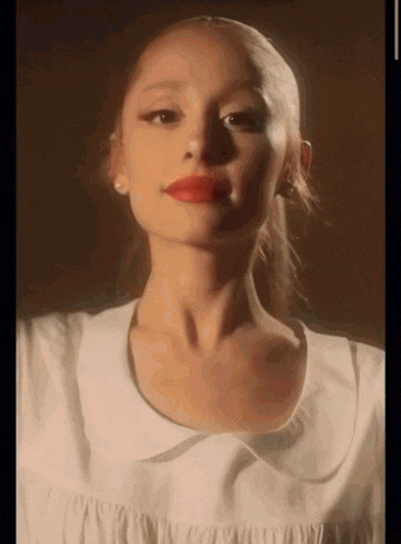 a close up of a woman 's face with red lips