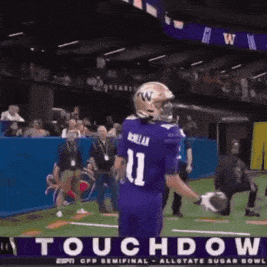 a football player in a purple uniform with the number 11 on the back