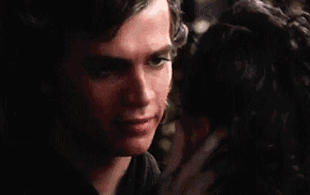 a close up of a man and a woman looking into each others eyes .